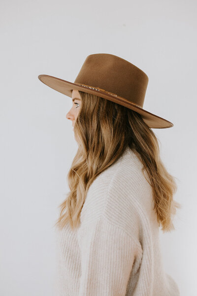 Profile of woman in hat.