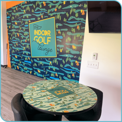 A large interior wall at The Indoor Golf Lounge covered in a branded mural