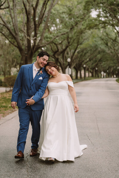 Latino newlyweds smiling walking in the park