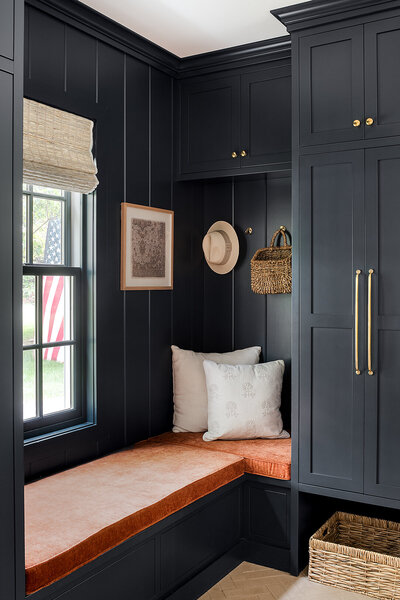 navy alcove with sitting area and cabinets