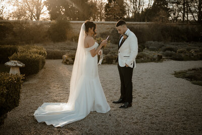 Bride and groom reading their vows to each other at Caswell House