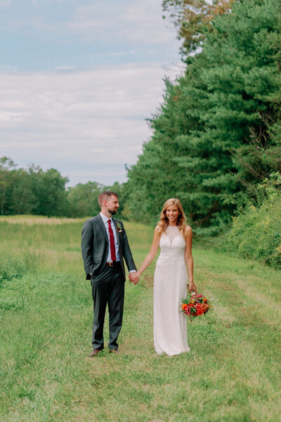 Nikki and her partner hold hands outdoors.