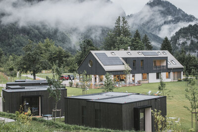 Exterior view of The Campus Alps Workbase, offering a modern and inspiring workspace surrounded by the stunning Alpine landscape, perfect for company retreats and remote work.