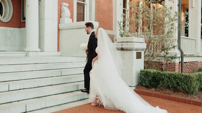 bride and groom walking up the front steps of The Admiral House