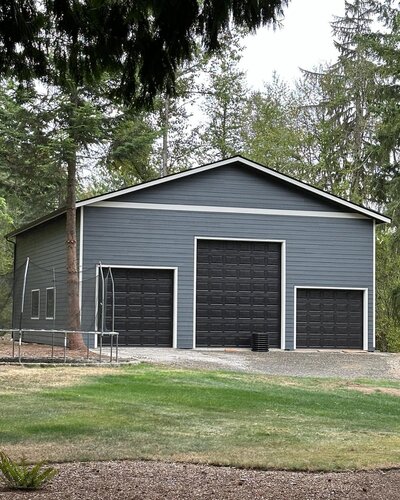 Grey garage by Northwest Pole Str