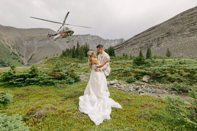 Capture the essence of romance with a photo of the bride and groom embracing at Fairmont Banff Springs Hotel. A perfect moment of love and elegance on their wedding day.