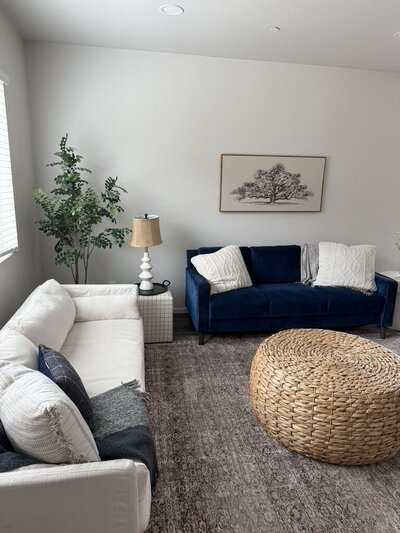 Bright, modern living room featuring neutral furniture, woven textures, and framed art curated by Kaitlyn Schultz Creative.