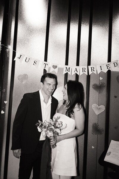 couple in boston public garden holding hands for elopement portraits on black and white medium format film 