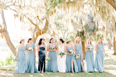 bride with bridesmaids at blue themed wedding
