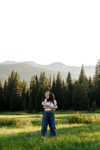 Montana couple laughing during a sunset photo session in the mountains