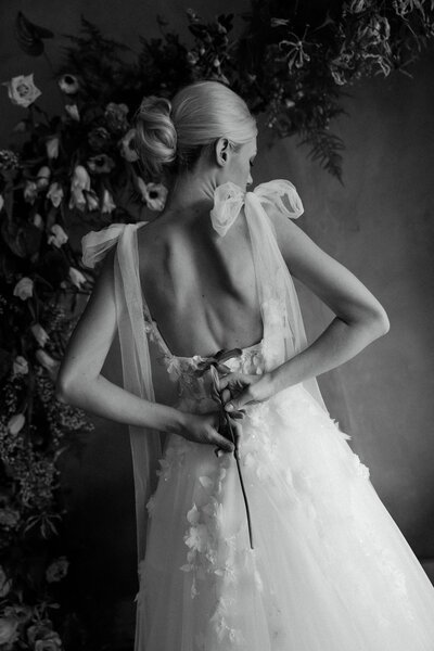 Black and white fine art bridal portrait captured in Fort Worth, Texas. A timeless and elegant wedding moment featuring a bride in a floral backdrop.