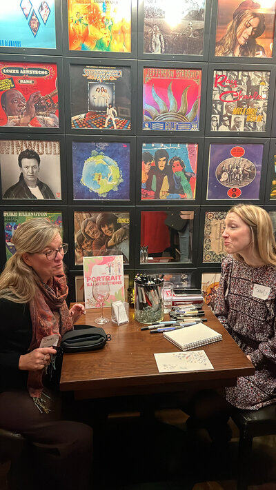 two women chatting at a table