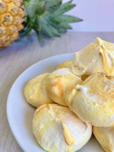 Yellow and white swirl hand piped meringues with pineapple.