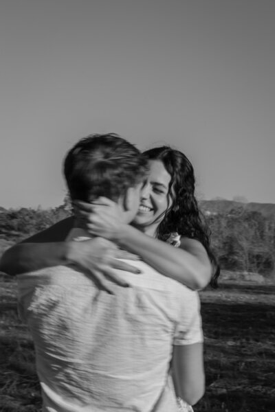 David picking up and twirling Elizabeth, in black and white.