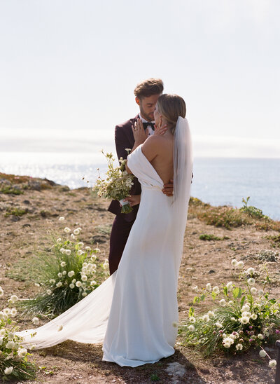 Stunning bride poses for portrait on her wedding day amidst wildflowers in Sonoma