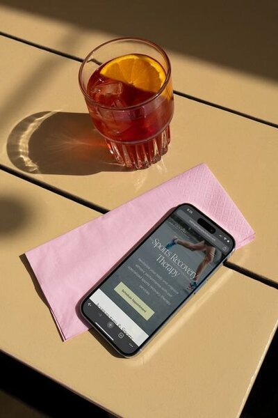 iPhone mockup displaying a modern Squarespace website for a sports recovery and physical therapy business — designed by Almost Always.