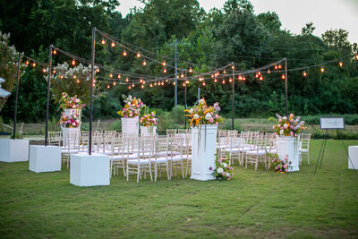 String lights, wedding chairs and flowers