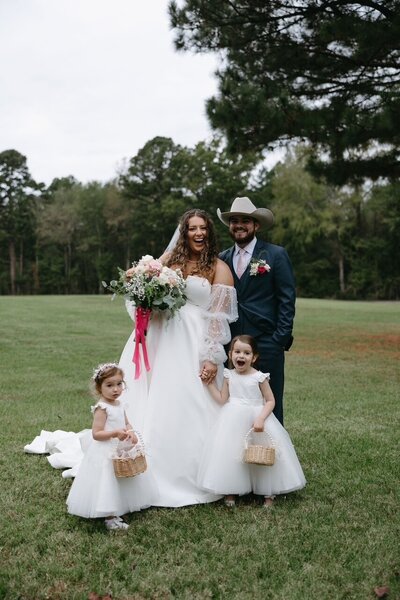 Bride & Groom in outdoor wedding ceremony at The Rosewood Venue in Mount Vernon, Texas.