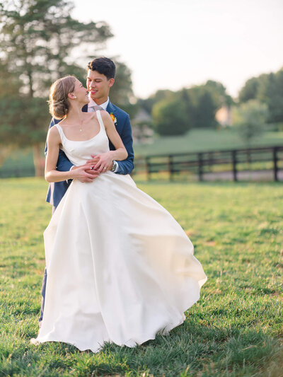Bride and Groom holding bouquet at The Boathouse at Sunday Park in Midlothian, Virginia. Taken by Charlottesville Wedding Photographer Bethany Aubre Photography.