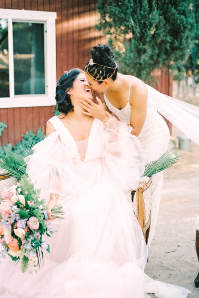 two brides embracing on wedding day