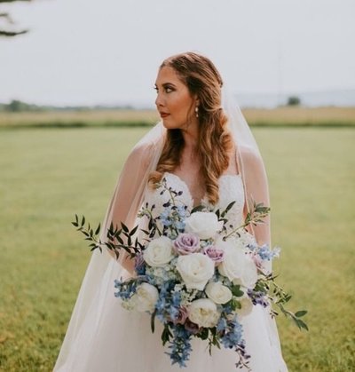 Bride with blue, white and lavender large bouquet