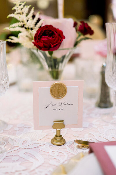 layered place cards for wedding with wax seal on table