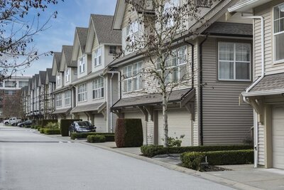 Street of tan multi-family houses