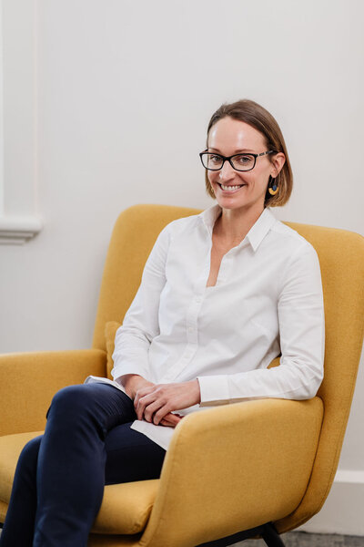 Dr-Sarah-Davenport-smiles-and-poses-in-her-consultation-room