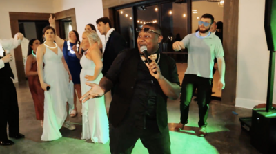 a DJ entertaining the crowd at a wedding