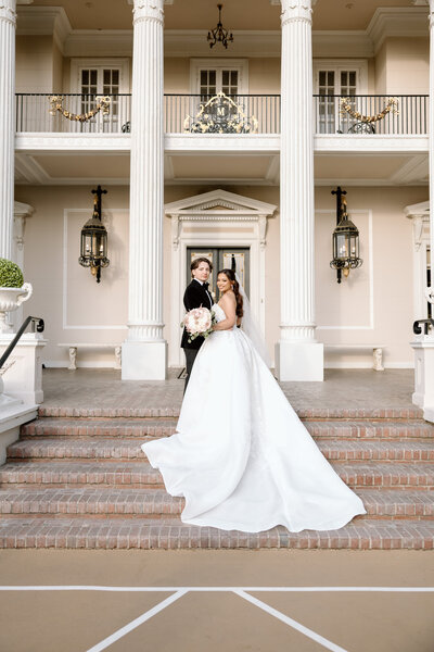 Bride and groom posing in front of the camera.