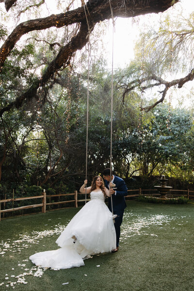 green gables wedding, bride on swing, groom pushing bride on a swing 