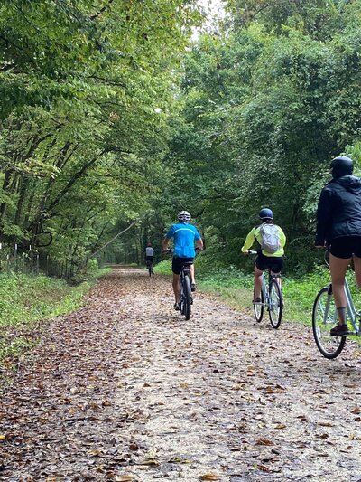 people riding along the woods on the katy trail bike tour from crossroads