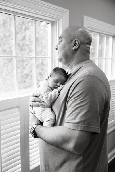 Dad holding tiny newborn baby in Elmhurst, IL