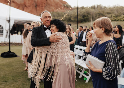 Emotional hug between parents at wedding