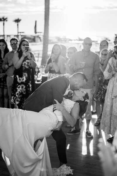 groom tipping bride back while kissing her