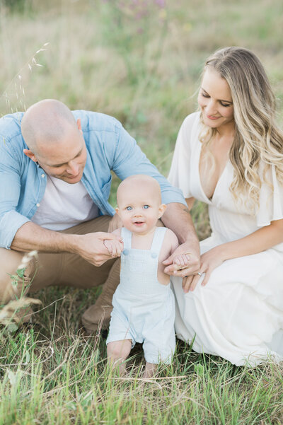 Family hugging on beach during family photoshoot with Sydney family photographer Sarah Vassallo