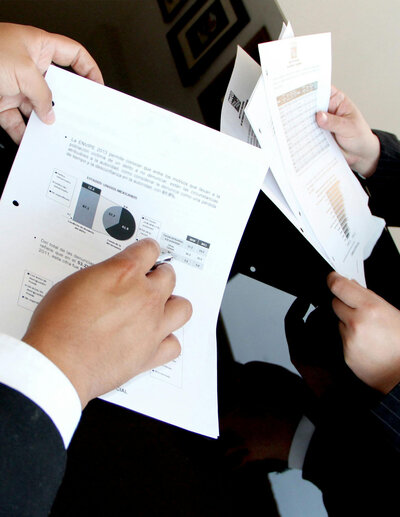 Google Ads campaign management team working on digital marketing statistics, dressed in elegant outfits, highlighting a professional approach to data analysis and campaign optimization.