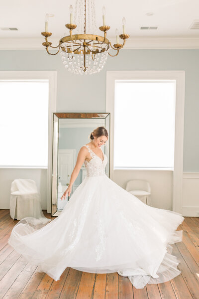 Bride spins in dress on wedding day in Charleston, South Carolina.