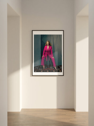 A printed wall portrait of  a woman wearing pink outfit
