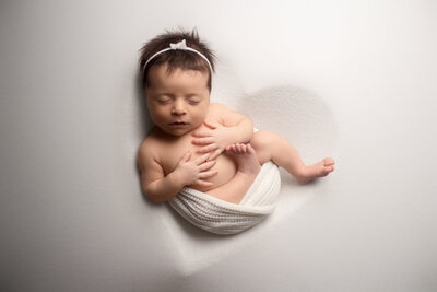 baby girl wearing little bear hat in froggy pose for newborn portrait