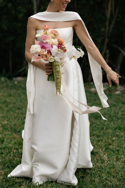 bride closing eyes wearing veil and jewels on her sleeves by wedding photographers naples fl