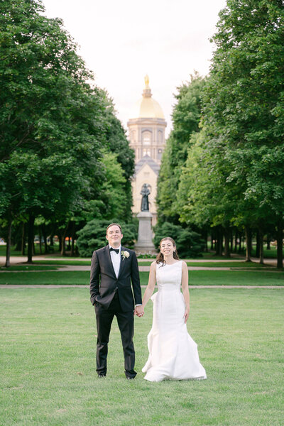 Bride and Groom in front of the Golden Dome during their portrait session on their wedding day on the campus of the University of Notre Dame