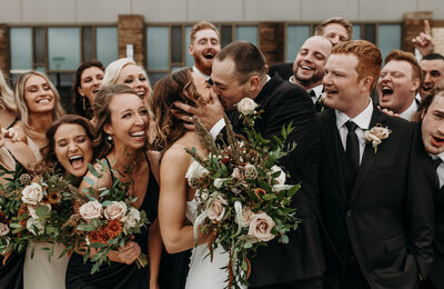 couple embracing in front of bridal party