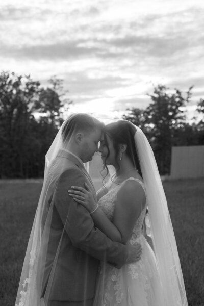 Close-up detail photo of a couple holding up their wedding rings, capturing a meaningful and intimate moment on their Kentucky wedding day.