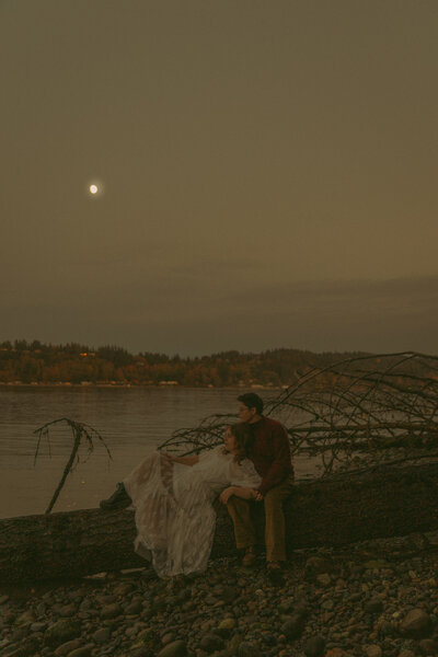 Man and woman romantically spin around, laughing in the middle of a  flowery field