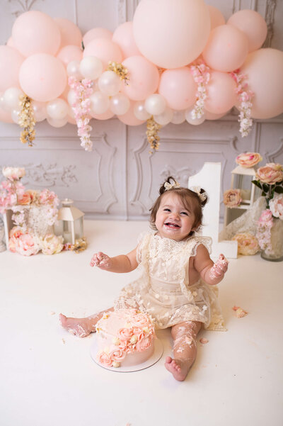 Baby celebrating her first birthday wearing a confetti dress