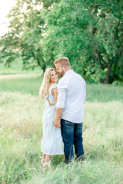 engaged couple photo in a field taken by tampa wedding photographer