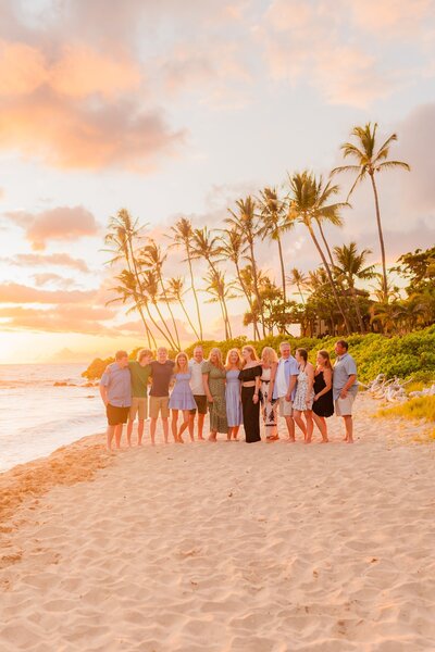 extended family portrait with several adults talking and laughing during sunset wailea family photoshoot with love and water
