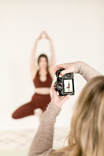 Woman taking photo of yoga class