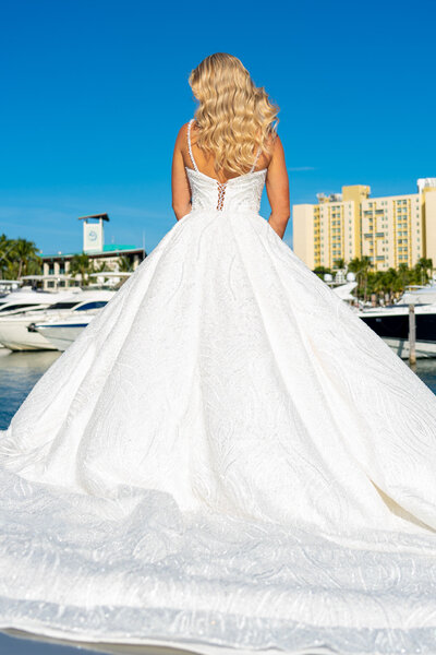 Back photoshoot of a beaded wedding dress with detachable skirt on a regal yacht